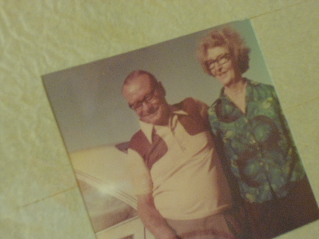 Grandparents beside car